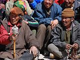 Mustang Lo Manthang Tiji Festival Day 3 04-1 Men Twirling Prayer Wheels and Counting Mantras On Beads One devout Buddhist pilgrim spins a prayer wheel while another fingers his 108 beads on day three of the Tiji Festival in Lo Manthang.